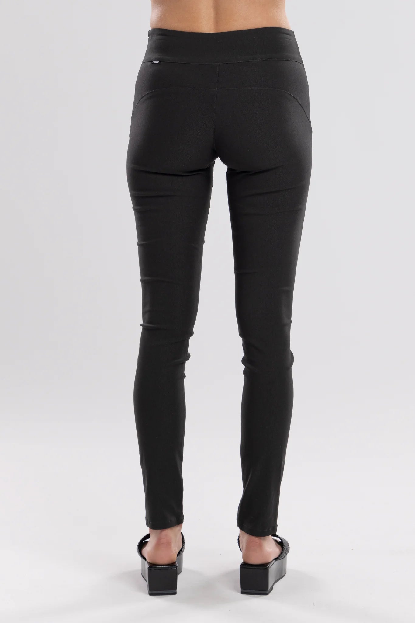 The NES Skinnie Minnies Pant is your go-to for sleek, everyday style with a modern edge. Crafted from the same super stretchy twill fabric you love, these pants are all about a flattering fit and effortless comfort. Featuring a cigarette-style slim leg, flat waistband, and a concealed side seam zip, the Skinnie Minnies offer a streamlined silhouette that's both polished and wearable.