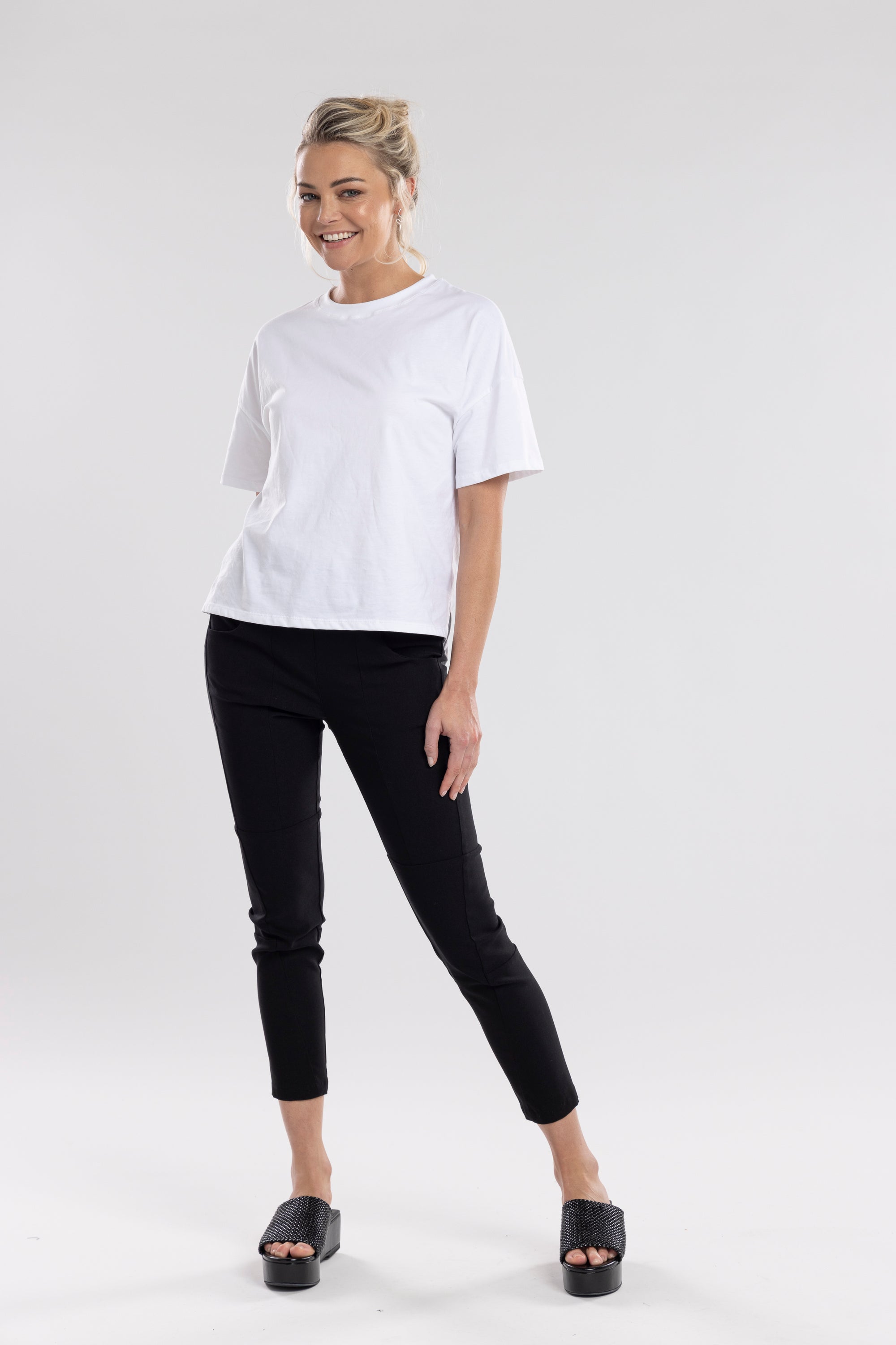 NES Section Pant is the perfect blend of style and comfort, featuring fabulous spliced detailing that adds a modern edge to your look. With a sleek flat front and an elasticated back, these pants offer a comfortable and flattering fit. Practical side pockets enhance the design, while the length finishes just above the ankle, creating a chic, tailored silhouette. Ideal for both casual and dressier occasions