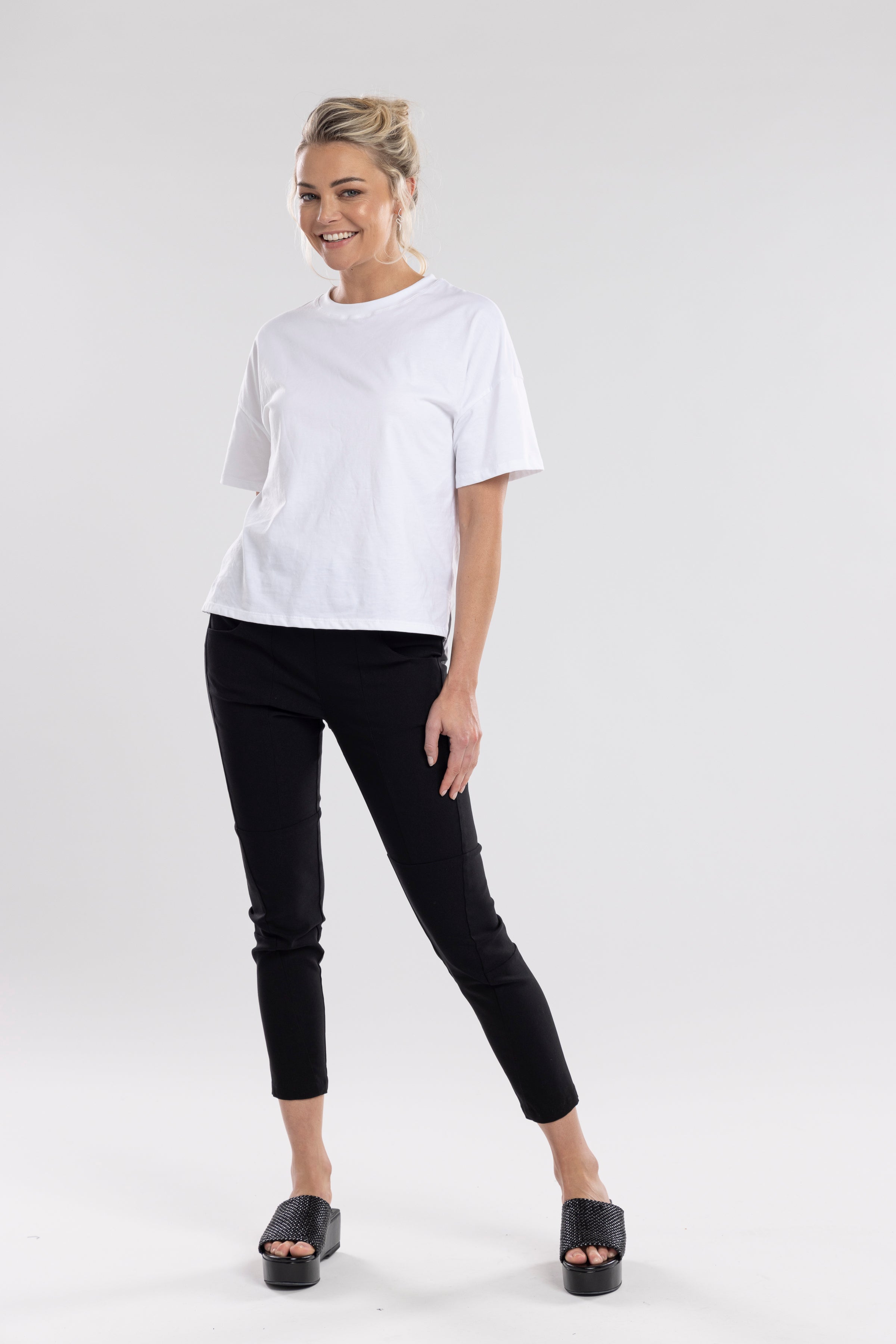 NES Section Pant is the perfect blend of style and comfort, featuring fabulous spliced detailing that adds a modern edge to your look. With a sleek flat front and an elasticated back, these pants offer a comfortable and flattering fit. Practical side pockets enhance the design, while the length finishes just above the ankle, creating a chic, tailored silhouette. Ideal for both casual and dressier occasions