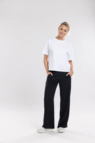 The NES Gin Pants are our absolute top-selling essential pants, designed to suit all body shapes. Featuring a flattering, classic cut, these pants are perfect for both dressing up and down, making them an ideal work pant and an effortless choice for everyday wear. The flat front, covered elasticated back, and flattering angled pockets ensure both comfort and sophistication.