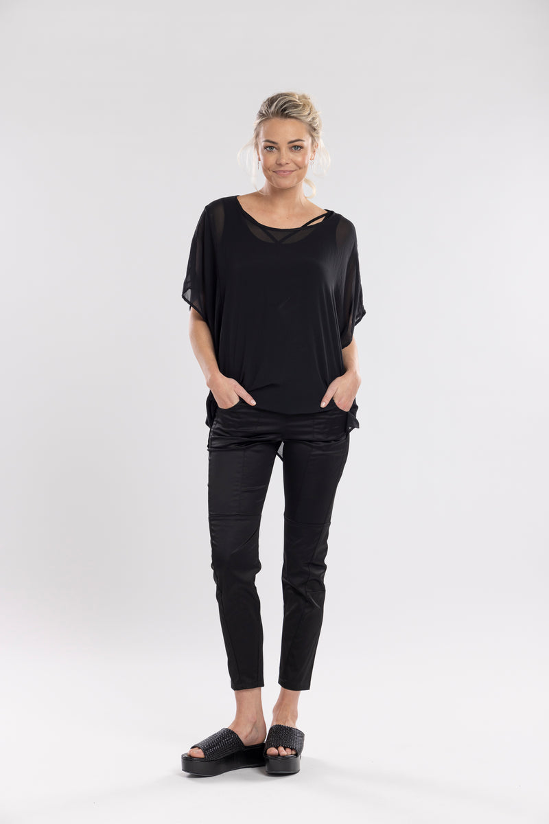 The Satin Section Pant is your go-to slightly more dressy NES essential, offering effortless style and unmatched comfort. With fabulous spliced detailing, this pant combines a sleek flat front with an elasticated back for the perfect fit. Side pockets provide practicality, while the 7/8 length and satin finish add an elevated touch to your look. Whether you're dressing up for a night out, office wear, or a special occasion, these versatile pants can easily be styled for any event. Elegant, stylish, and desi