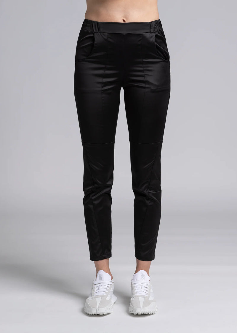 The Satin Section Pant is your go-to slightly more dressy NES essential, offering effortless style and unmatched comfort. With fabulous spliced detailing, this pant combines a sleek flat front with an elasticated back for the perfect fit. Side pockets provide practicality, while the 7/8 length and satin finish add an elevated touch to your look. Whether you're dressing up for a night out, office wear, or a special occasion, these versatile pants can easily be styled for any event. Elegant, stylish, and desi