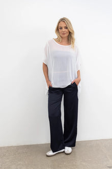 The NES Satin Gin Pants are our absolute top-selling dressy essential pants, designed to flatter all body shapes. Featuring a classic cut, these versatile pants are perfect for both dressing up and down, making them an ideal choice for an evening out or as a chic, dressed-up everyday look. The flat front, covered elasticated back, and flattering angled pockets provide both comfort and sophistication. Crafted from a floaty, cool-to-the-touch poly satin fabric that’s anti-crease