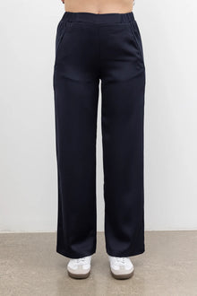 The NES Satin Gin Pants are our absolute top-selling dressy essential pants, designed to flatter all body shapes. Featuring a classic cut, these versatile pants are perfect for both dressing up and down, making them an ideal choice for an evening out or as a chic, dressed-up everyday look. The flat front, covered elasticated back, and flattering angled pockets provide both comfort and sophistication. Crafted from a floaty, cool-to-the-touch poly satin fabric that’s anti-crease