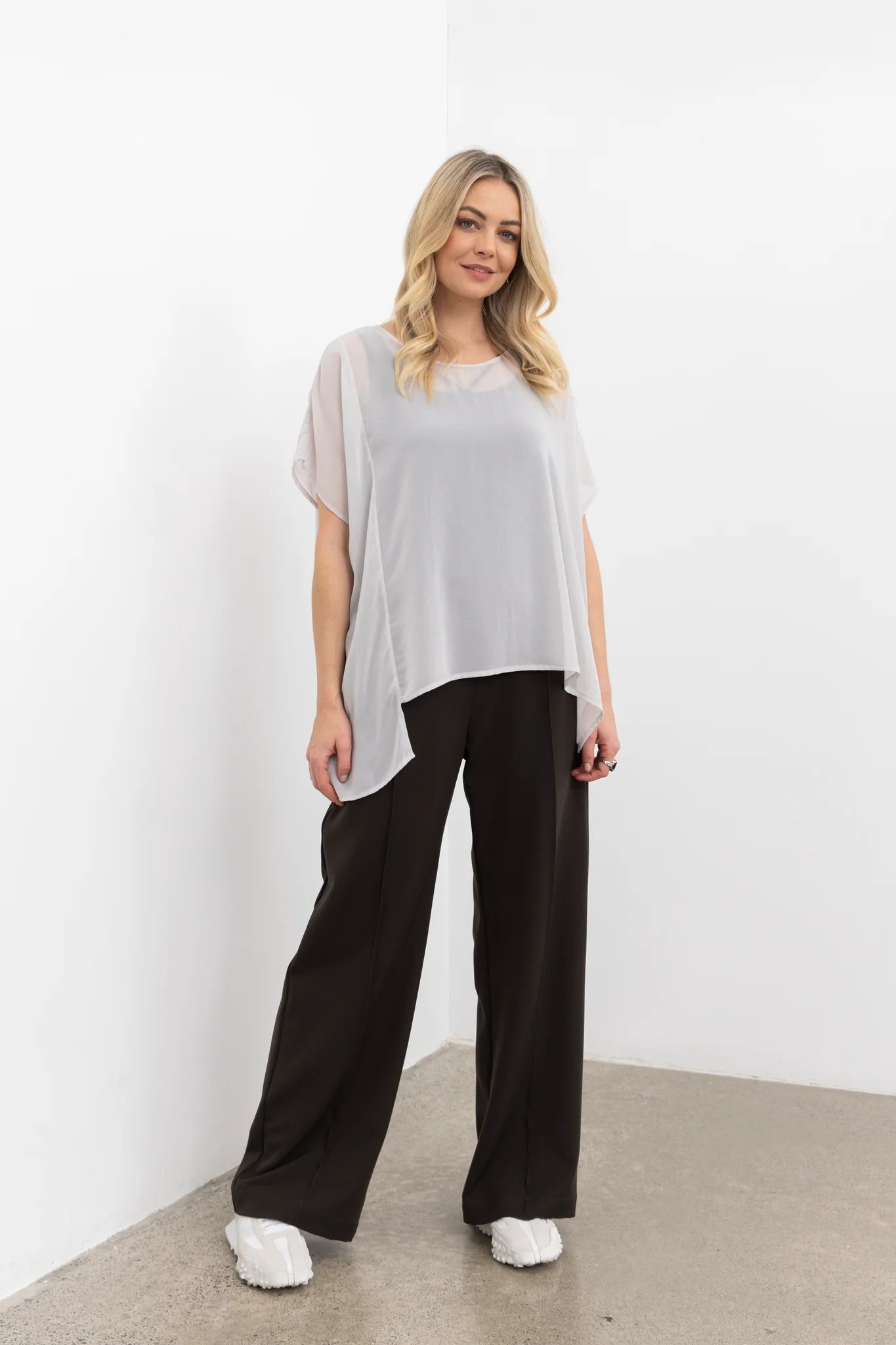 The NES Ginnie Pant is a stylish update to our top-selling Gin Pants, now featuring a pin stitch pleat down the front legs for an elongated, flattering silhouette. With a classic cut that’s easy to dress up or down, these pants are perfect for both work and everyday wear. The centre leg pin stitch detailing adds a touch of sophistication, while the flat front and covered elasticated back provide a comfortable, secure fit. The flattering angled panel at the front enhances the shape, and the full-length strai