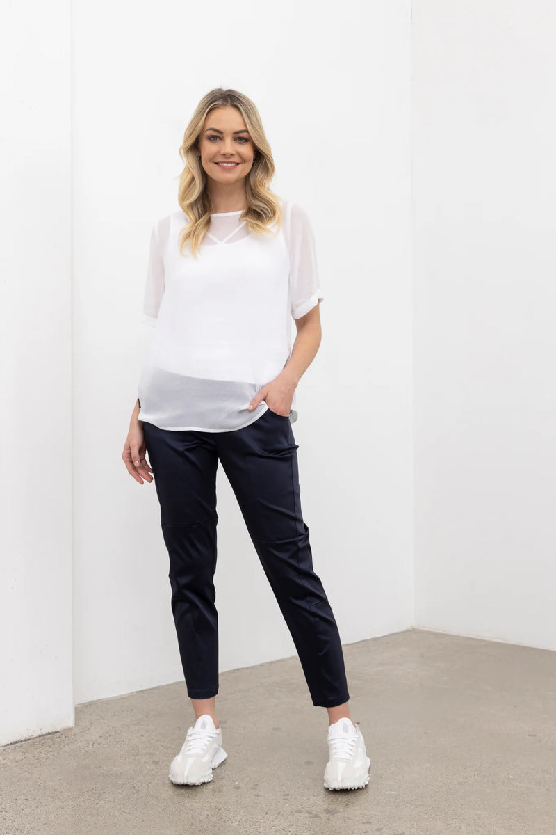 NES Charlie Top – Effortlessly Versatile &amp; Elegant

The N-E-S Charlie Top in chiffon is the ultimate versatile addition to your wardrobe. This elegant, lightweight chiffon t-shirt-style top features a straight-across hem and sleeves that finish just above the elbow, offering a relaxed and flattering fit. Perfectly paired with jeans, skirts, or layered under a blazer for a polished office look, it effortlessly adapts to various styles and occasions. Pt chiffon wear back with a lattice singlet