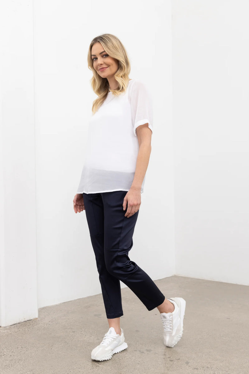 NES Charlie Top – Effortlessly Versatile &amp; Elegant

The N-E-S Charlie Top in chiffon is the ultimate versatile addition to your wardrobe. This elegant, lightweight chiffon t-shirt-style top features a straight-across hem and sleeves that finish just above the elbow, offering a relaxed and flattering fit. Perfectly paired with jeans, skirts, or layered under a blazer for a polished office look, it effortlessly adapts to various styles and occasions. Pt chiffon wear back with a lattice singlet
