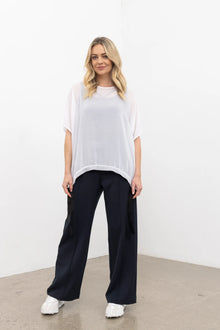 The NES Ginnie Pant is a stylish update to our top-selling Gin Pants, now featuring a pin stitch pleat down the front legs for an elongated, flattering silhouette. With a classic cut that’s easy to dress up or down, these pants are perfect for both work and everyday wear. The centre leg pin stitch detailing adds a touch of sophistication, while the flat front and covered elasticated back provide a comfortable, secure fit. The flattering angled panel at the front enhances the shape, and the full-length strai
