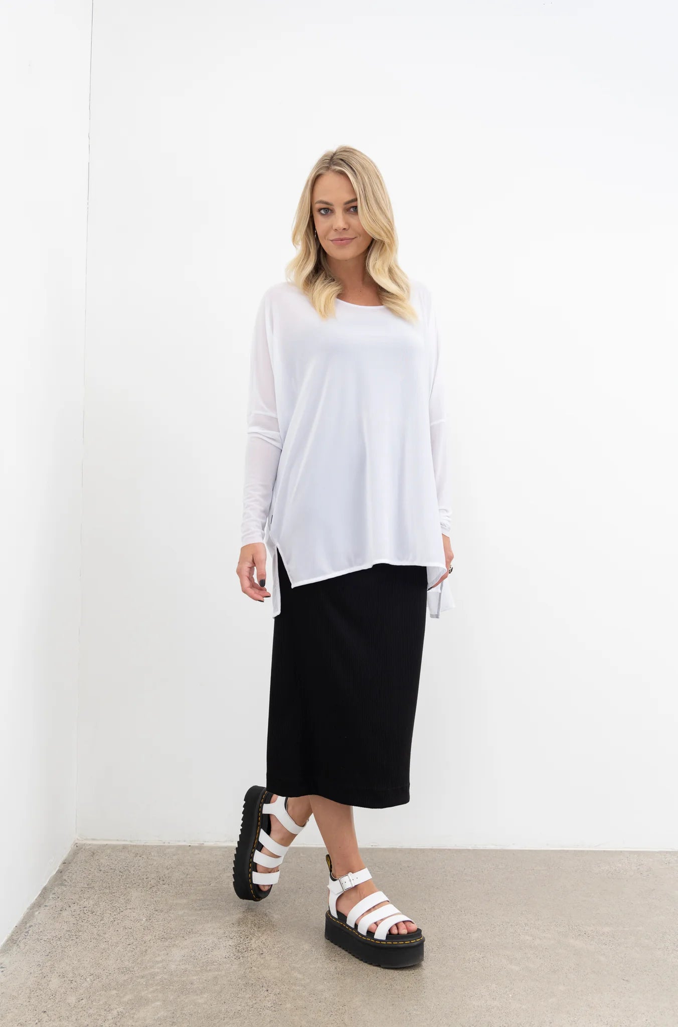 NES Step Mesh top, Black. Our Step Mesh Top is soft and floaty. Easy wearing, made in a sheer mesh fabric, features side splits a hi-low hemline, wide neckline. Fitted raw edge sleeved.
