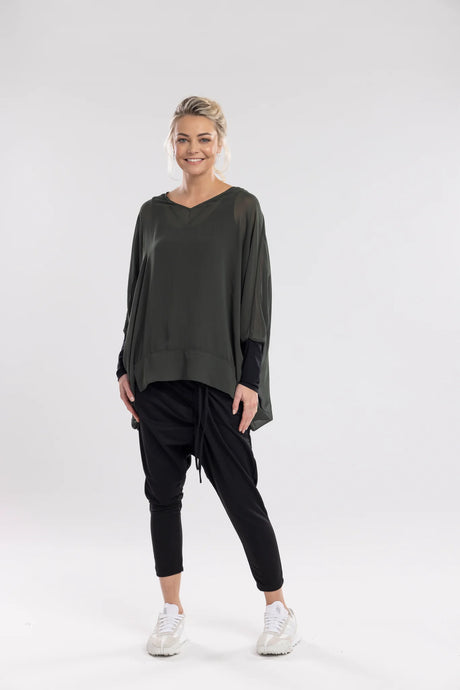 The NES Virtue Tunic is designed to make a statement with its unique reversible style. Featuring a soft V-neckline and batwing 3/4 sleeves, this tunic effortlessly blends comfort and style. The black mesh cuffs add a touch of modern sophistication, while the long, draped back creates a flowing, flattering silhouette. At tunic length, it’s perfect for layering over our NES Lattice Singlet or Electra Slip. Versatile and chic, the Virtue Tunic is a must-have for anyone looking to elevate their wardrobe with ea