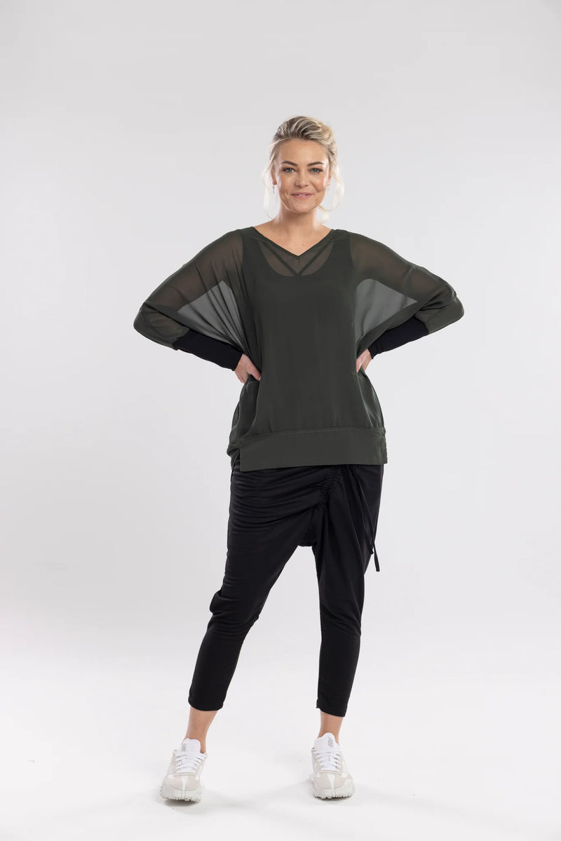 The NES Virtue Tunic is designed to make a statement with its unique reversible style. Featuring a soft V-neckline and batwing 3/4 sleeves, this tunic effortlessly blends comfort and style. The black mesh cuffs add a touch of modern sophistication, while the long, draped back creates a flowing, flattering silhouette. At tunic length, it’s perfect for layering over our NES Lattice Singlet or Electra Slip. Versatile and chic, the Virtue Tunic is a must-have for anyone looking to elevate their wardrobe with ea
