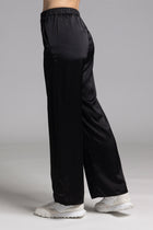 The NES Satin Gin Pants are our absolute top-selling dressy essential pants, designed to flatter all body shapes. Featuring a classic cut, these versatile pants are perfect for both dressing up and down, making them an ideal choice for an evening out or as a chic, dressed-up everyday look. The flat front, covered elasticated back, and flattering angled pockets provide both comfort and sophistication. Crafted from a floaty, cool-to-the-touch poly satin fabric that’s anti-crease