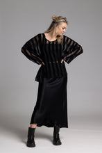 Load image into Gallery viewer, The NES Muse Skirt is the ultimate statement piece—elegant, fluid, and designed to stand out. With a flattering bias cut and a soft concave front that flows into a dropped back hem, this skirt moves beautifully with the body. The wide elasticated waistband offers all-day comfort, while the luxe drape of 100% viscose adds a sophisticated sheen. Multi-seasonal and effortlessly versatile, the Muse Skirt is perfect for pairing with everything from a casual tee to a tailored blazer.
