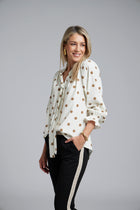 N-E-S Esme Top, designed and made in NZ – a relaxed women’s top with curved front and back hem, finishing just below the waistband; lightweight and breathable, available in Black Polka Dot (100% viscose georgette with butter-yellow mini spots) or Ivory Spot (100% polyester satin-back crepe with bronze oversized spots) for soft drape, gentle movement, and effortless, polished everyday wear.