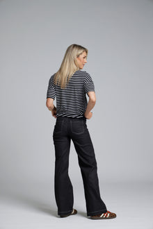 The N-E-S DollyB Denim Pants – a wide-leg stretch denim pant with fold-down rib waistband and contrast stitching. Available in blue or black denim. NZ made.