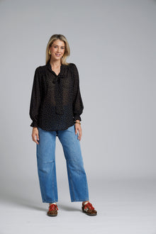 N-E-S Esme Top, designed and made in NZ – a relaxed women’s top with curved front and back hem, finishing just below the waistband; lightweight and breathable, available in Black Polka Dot (100% viscose georgette with butter-yellow mini spots) or Ivory Spot (100% polyester satin-back crepe with bronze oversized spots) for soft drape, gentle movement, and effortless, polished everyday wear.