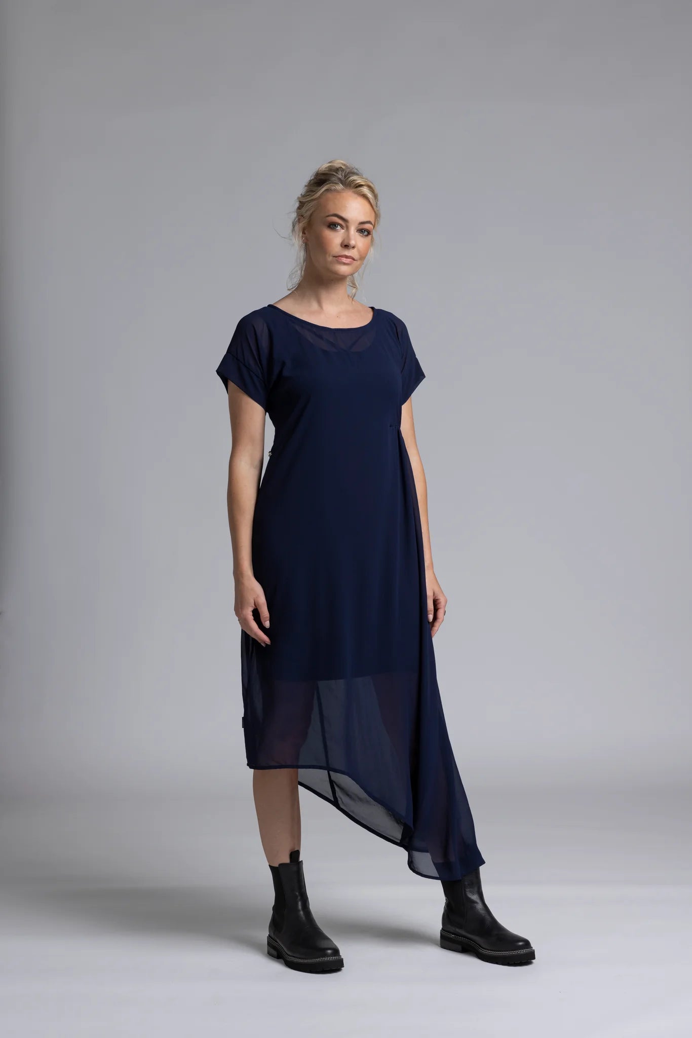 The NES Flow Dress is a multi-seasonal, versatile style that seamlessly transitions from casual to formal occasions. This dress offers a variety of styling options—wear it draped down across the front for a relaxed look, or cinch it up at the side using the adjustable side button and hem loopers for a more structured appearance. The perfect balance of comfort and elegance, this dress can be styled with our Lattice Slip