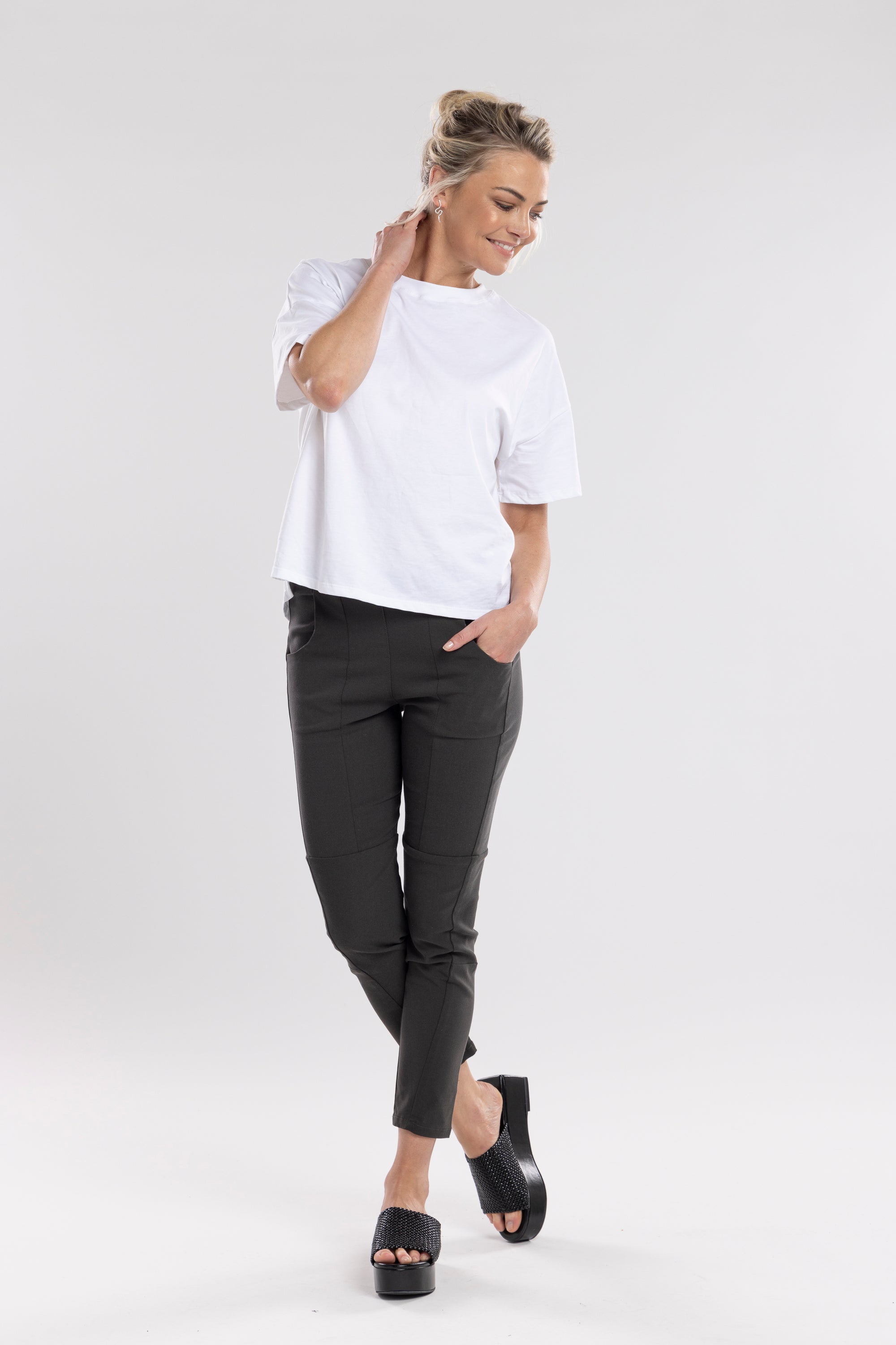 NES Section Pant is the perfect blend of style and comfort, featuring fabulous spliced detailing that adds a modern edge to your look. With a sleek flat front and an elasticated back, these pants offer a comfortable and flattering fit. Practical side pockets enhance the design, while the length finishes just above the ankle, creating a chic, tailored silhouette. Ideal for both casual and dressier occasions