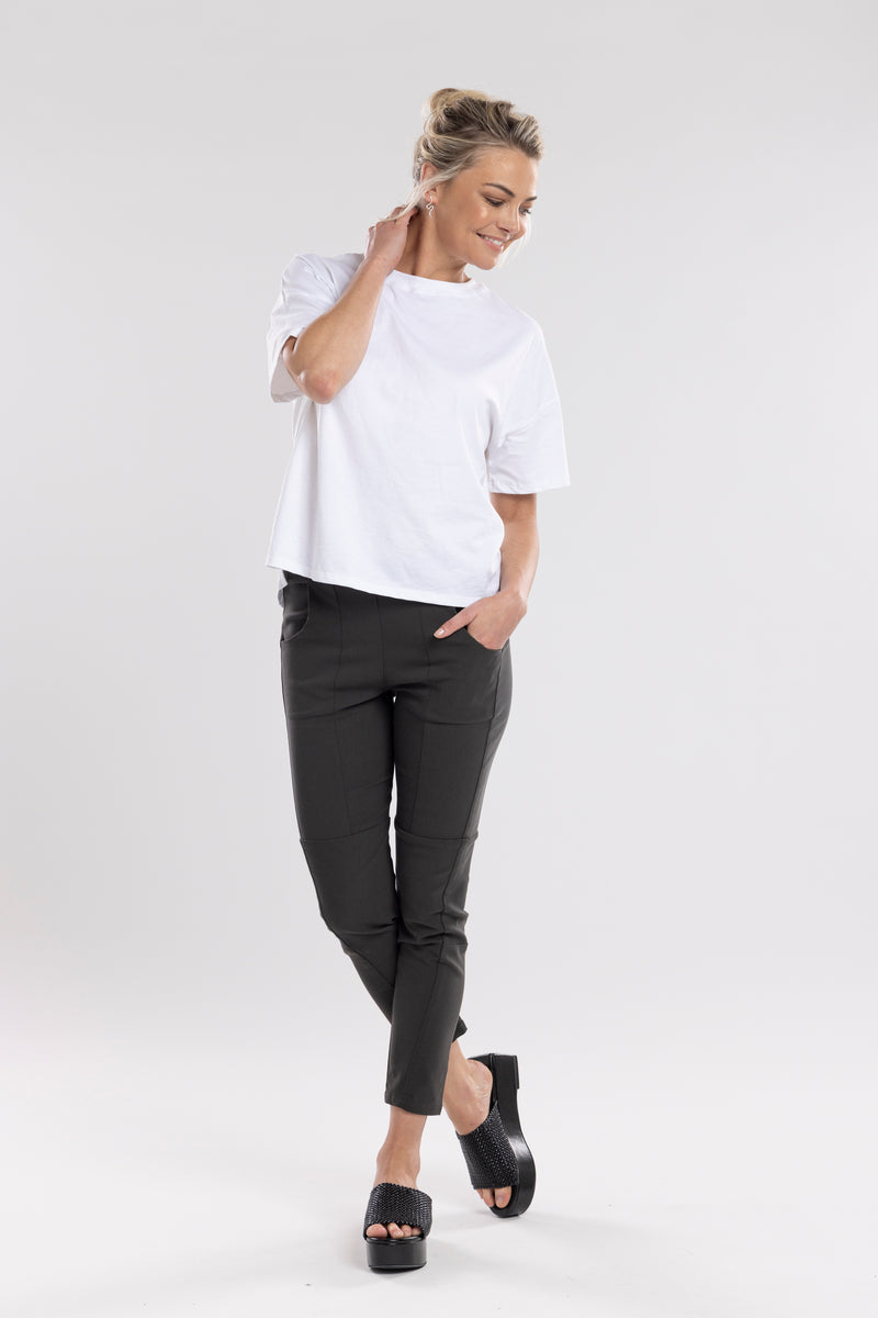 NES Section Pant is the perfect blend of style and comfort, featuring fabulous spliced detailing that adds a modern edge to your look. With a sleek flat front and an elasticated back, these pants offer a comfortable and flattering fit. Practical side pockets enhance the design, while the length finishes just above the ankle, creating a chic, tailored silhouette. Ideal for both casual and dressier occasions