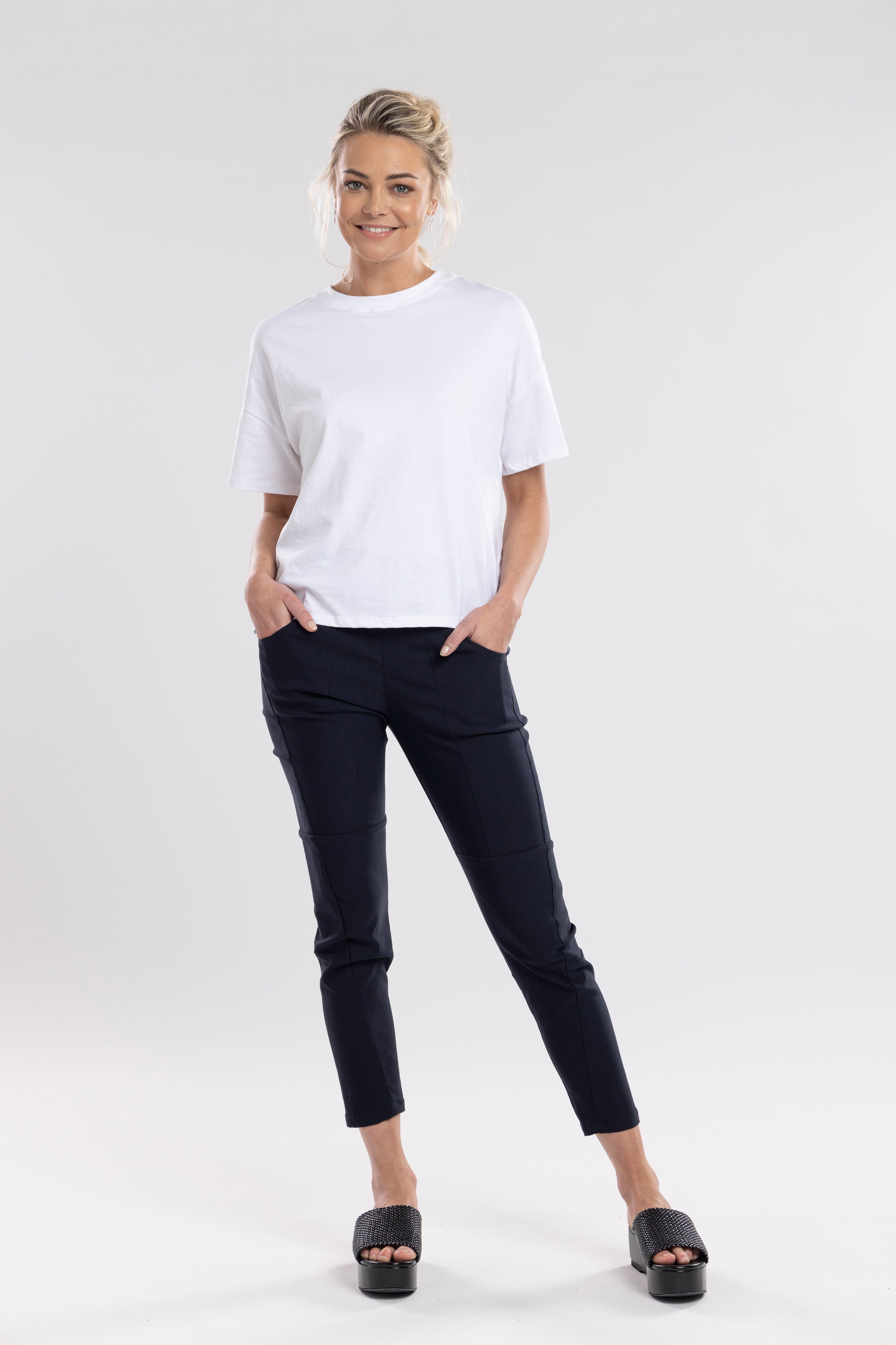NES Section Pant is the perfect blend of style and comfort, featuring fabulous spliced detailing that adds a modern edge to your look. With a sleek flat front and an elasticated back, these pants offer a comfortable and flattering fit. Practical side pockets enhance the design, while the length finishes just above the ankle, creating a chic, tailored silhouette. Ideal for both casual and dressier occasions