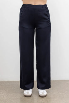 The NES Gin Satin Pant – a straight leg hammered satin pant with flat front, elastic back and fluid drape. Available in Black and Ink. NZ made.