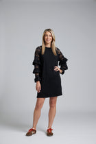 NES Luxa Dress by N-E-S – a black merino dress with sculptural ruffled lace sleeves, subtle gathers and above-knee length. Bold, modern and NZ made.