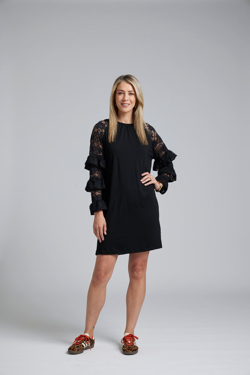 NES Luxa Dress by N-E-S – a black merino dress with sculptural ruffled lace sleeves, subtle gathers and above-knee length. Bold, modern and NZ made.