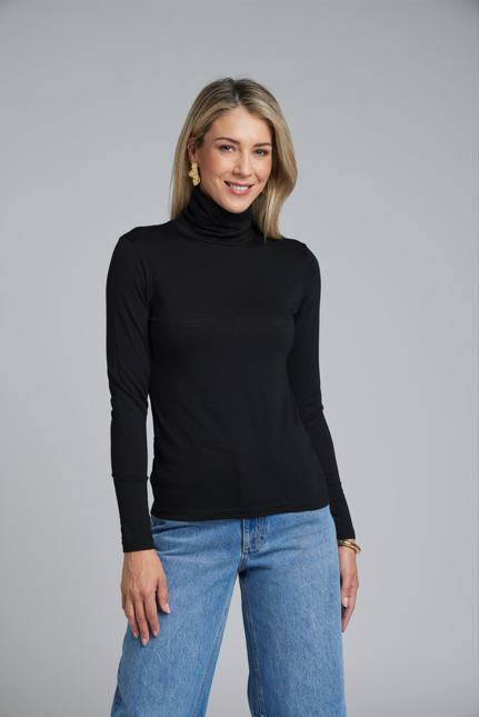The NES Merino Funnel Neck Top by N-E-S. A warm, soft 100% merino layer with funnel neckline and long sleeves. Wear alone or layered. Winter essential. NZ made.