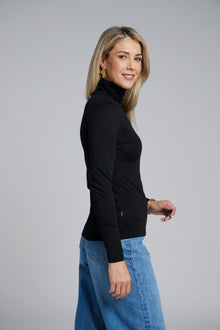 The NES Merino Funnel Neck Top by N-E-S. A warm, soft 100% merino layer with funnel neckline and long sleeves. Wear alone or layered. Winter essential. NZ made.
