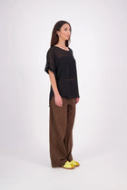 A customer favourite, the NES Cross Top is crafted in lightweight chiffon for an easy, elegant drape. This flattering t-shirt style features mid-length sleeves with folded cuffs, a soft scooped hem, and a unique crossover yoke detail that wraps from front to back. Perfect dressed up or down, and best layered with a NES Lattice Singlet underneath for coverage and style.

Our model is 174cm and wears a XS (8) NES fit advise: Standard fit

Composition: PT Chiffon

Designed and Made in New Zealand
