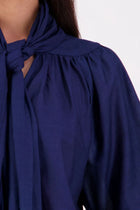 The N-E-S Nova Shirt blends the best of our Ayla, Mon, and Del shirts into one must-have wardrobe piece. Featuring elbow-length sleeves, a soft drop hem at the front and back, and a playful neck tie that can be styled multiple ways—bowed, looped, or reversed and tied at the back. Designed for versatility and charm, the Nova Shirt is a timeless addition to elevate your everyday style.
Our model is 174cm and wear a XS/S (8-10)
Composition: Cotton voile
Designed in New Zealand
