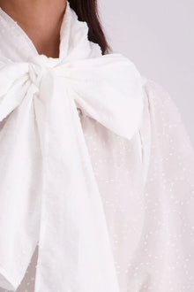 The N-E-S Nova Shirt blends the best of our Ayla, Mon, and Del shirts into one must-have wardrobe piece. Featuring elbow-length sleeves, a soft drop hem at the front and back, and a playful neck tie that can be styled multiple ways—bowed, looped, or reversed and tied at the back. Designed for versatility and charm, the Nova Shirt is a timeless addition to elevate your everyday style.

Our model is 174cm and wear a XS/S (8-10)

Composition: Cotton

Designed and Made in New Zealand