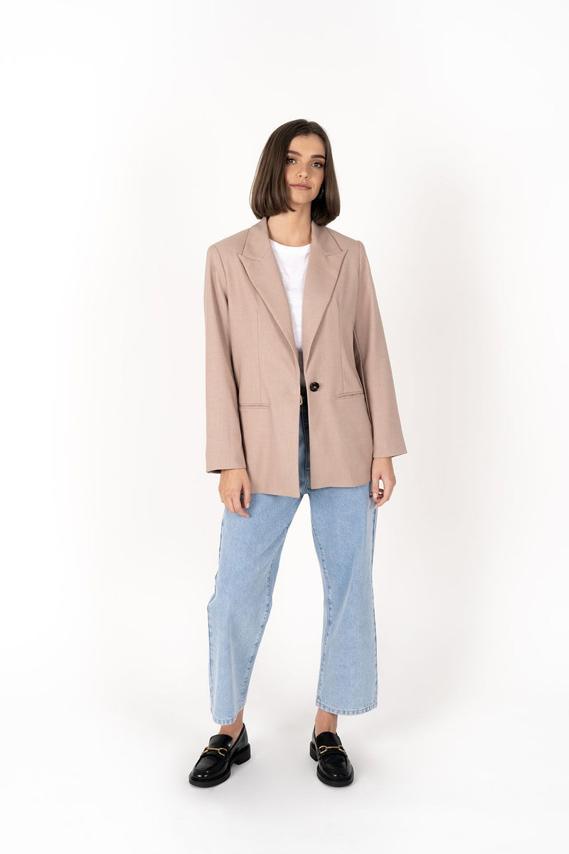 The Cosmo Blazer will instantly add effortless sophistication to any outfit! Lightweight enough to not feel heavy or restrictive but will still provide that extra layer of warmth. We love wearing her with jeans and a white tee for a chic weekend look, or pair with a pant or skirt to create a classic suit for days in the office.

Smart casual blazer with a soft, boxy silhouette.
Small subtle shoulder pads.
Lined collar with fold back lapel.
Lightweight, soft, stretch fabric with beautiful drape.
Functional p