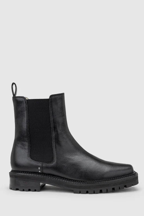 Chaos & Harmony OLLIE Boot, a blend of sustainable fashion and distinctive design. Crafted from black recycled leather, these boots are a testament to both style and environmental consciousness. The square toe shape sets a contemporary tone, offering a unique silhouette that stands out. Black recycled leather chelsea boot, Soft leather lined