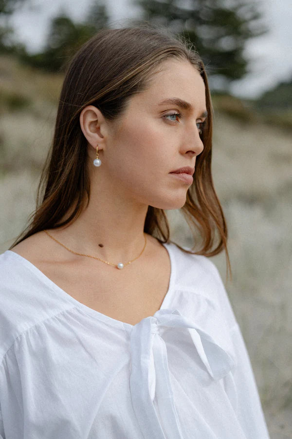 A perfect fusion of modern elegance and timeless charm—the Castel &amp; Co Orb Earrings feature a sleek, polished sphere paired with a delicate pearl drop for effortless sophistication. The contrast between the luminous pearl and the structured orb creates a refined yet contemporary look, making these earrings ideal for both everyday luxury and special occasions. Classic, graceful, and endlessly wearable.

Main material: gold plating, stainless steel
Closure type: congo
Earrings size: 1 x 2.5 cm
Waterproof 