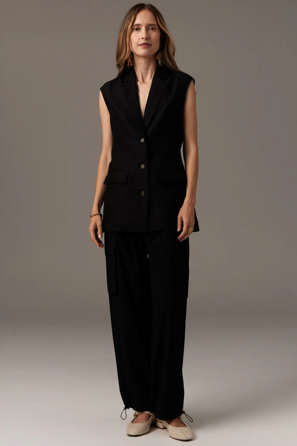 POL, Tech Cargo Pant. Made from an elevated technical fabric, luxe take on streetwear.
-Hook and bar and zip fly closure.
-Elasticised waistband - elastic drawcord with nickel toggle at either side of the fly.
-Hip pockets.
-Back pockets with cargo flap detail.
-Wide leg fit.
-Cargo pockets on outer leg.
-Elastic drawcord with nickel toggle detail creates and adjustable silhouette - wear loose or draw in for a tapered effect. -90% Nylon / 10% Spandex.