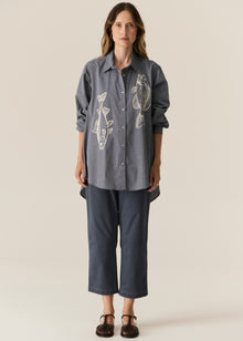 POL CASSIS FISH SHIRT
-Classic shirt collar.
-Button closure through the centre front.
-Gathered detail from yoke at the centre back.
-In-house designed placement fish print on either side at the front.
-Full length sleeves.
-Gathers at the cuffs - two button closure.
-Oversized fit through the body - longline silhouette.
-Hem curves down at the centre back.
-A-line shape.
-Available in Denim/Pebble and Natural/Berry.
100% COTTON