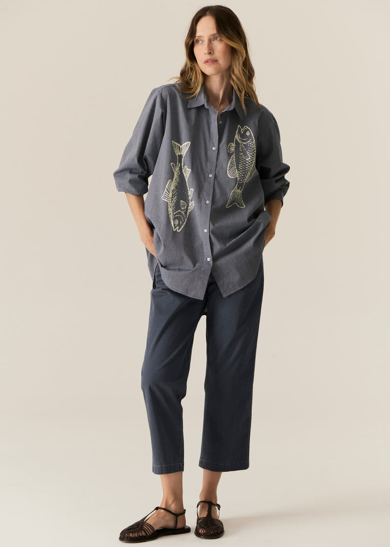 POL CASSIS FISH SHIRT
-Classic shirt collar.
-Button closure through the centre front.
-Gathered detail from yoke at the centre back.
-In-house designed placement fish print on either side at the front.
-Full length sleeves.
-Gathers at the cuffs - two button closure.
-Oversized fit through the body - longline silhouette.
-Hem curves down at the centre back.
-A-line shape.
-Available in Denim/Pebble and Natural/Berry.
100% COTTON
