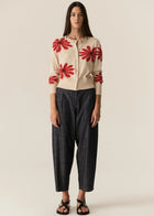 POL | LASK DAISY CARDI
-Round, ribbed neckline.
-Matching button closure through the centre front.
-Soft lightweight cotton yarn - perfect for layering in Spring.
-Intarsia Daisy detail - petals in cotton, centre in lurex yarn.
-Full length sleeves - deep ribbed cuffs.
-Regular fit through the body.
-Deep ribbed hem.
-Marisa is 179cm tall and a size 8, wearing a size S in all colours.
-Approximate length in cm by size: XS/52cm, S/53cm, M/54cm, L/55cm, XL/56cm.
-97% Cotton / 3% Metallic.