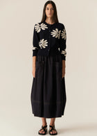 POL | LASK DAISY CARDI
-Round, ribbed neckline.
-Matching button closure through the centre front.
-Soft lightweight cotton yarn - perfect for layering in Spring.
-Intarsia Daisy detail - petals in cotton, centre in lurex yarn.
-Full length sleeves - deep ribbed cuffs.
-Regular fit through the body.
-Deep ribbed hem.
-Marisa is 179cm tall and a size 8, wearing a size S in all colours.
-Approximate length in cm by size: XS/52cm, S/53cm, M/54cm, L/55cm, XL/56cm.
-97% Cotton / 3% Metallic.