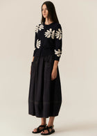POL | LASK DAISY CARDI
-Round, ribbed neckline.
-Matching button closure through the centre front.
-Soft lightweight cotton yarn - perfect for layering in Spring.
-Intarsia Daisy detail - petals in cotton, centre in lurex yarn.
-Full length sleeves - deep ribbed cuffs.
-Regular fit through the body.
-Deep ribbed hem.
-Marisa is 179cm tall and a size 8, wearing a size S in all colours.
-Approximate length in cm by size: XS/52cm, S/53cm, M/54cm, L/55cm, XL/56cm.
-97% Cotton / 3% Metallic.