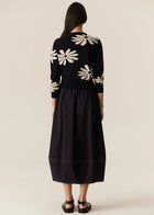 POL | LASK DAISY CARDI
-Round, ribbed neckline.
-Matching button closure through the centre front.
-Soft lightweight cotton yarn - perfect for layering in Spring.
-Intarsia Daisy detail - petals in cotton, centre in lurex yarn.
-Full length sleeves - deep ribbed cuffs.
-Regular fit through the body.
-Deep ribbed hem.
-Marisa is 179cm tall and a size 8, wearing a size S in all colours.
-Approximate length in cm by size: XS/52cm, S/53cm, M/54cm, L/55cm, XL/56cm.
-97% Cotton / 3% Metallic.