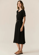FAIRE BELTED DRESS

Made from a drapey soft suiting, the Faire Belted Dress is an elevated everyday style that can be dressed up or down.
-Slash neckline.
-Short sleeves.
-Relaxed fit can be cinched in with the matching belt.
-Feature nickel buckle on the belt.
-Hip pockets.
-A-line midi length skirt.
-Topstitch detailing throughout.
-Available in Black &amp; Khaki&nbsp;
-Fabric has a natural crinkle texture.