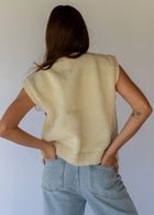 HOBO AND HATCH | Petal Vest - Hand-knitted cream wool vest crafted from 100% New Zealand wool, featuring delicate floral embroidery inspired by spring blooms, coconut button closure, and front patch pockets. Designed with a relaxed silhouette for effortless layering over winter knitwear or pairing with denim. Ethically handcrafted in Nepal alongside local artisans.