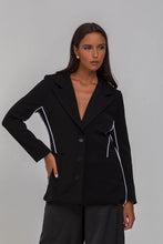 Load image into Gallery viewer, BLAK LUXE

Indulge in the luxury of our Pipe Dream Blazer - Black with White Piping. This monochromatic masterpiece, crafted from a blend of Polyester and Nylon, boasts a sophisticated, tailored fit.
