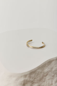 Gold open cuff bracelet with a sleek, sculptural design. The Castel & Co Quinn Cuff is crafted from gold-plated stainless steel with a smooth, polished finish and an easy open fit, ideal for larger wrists. Waterproof, hypoallergenic, and designed for comfortable everyday wear.