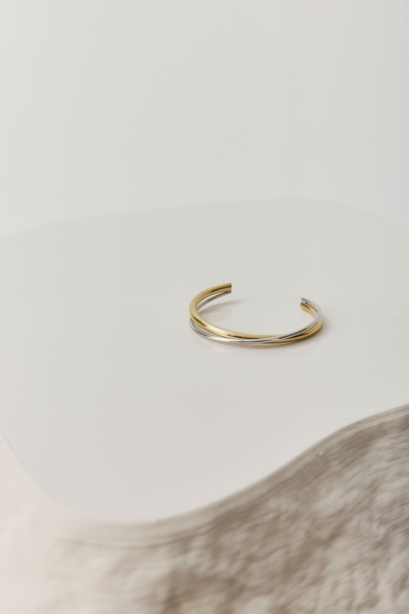 Gold open cuff bracelet with a sleek, sculptural design. The Castel & Co Quinn Cuff is crafted from gold-plated stainless steel with a smooth, polished finish and an easy open fit, ideal for larger wrists. Waterproof, hypoallergenic, and designed for comfortable everyday wear.