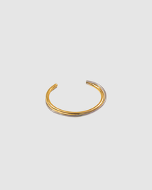 Gold open cuff bracelet with a sleek, sculptural design. The Castel & Co Quinn Cuff is crafted from gold-plated stainless steel with a smooth, polished finish and an easy open fit, ideal for larger wrists. Waterproof, hypoallergenic, and designed for comfortable everyday wear.