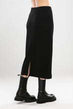 Load image into Gallery viewer, The NES Ribs Skirt is an effortless style meets all-day comfort in a skirt. Designed to gently skim the body without clinging, it features a soft elasticated waistband, centre back seam, and split for easy movement. The ribbed polyester/spandex blend offers the perfect balance of stretch and structure — making it an easy go-to for everyday wear or elevated layering.
