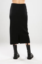 Load image into Gallery viewer, The NES Ribs Skirt is an effortless style meets all-day comfort in a skirt. Designed to gently skim the body without clinging, it features a soft elasticated waistband, centre back seam, and split for easy movement. The ribbed polyester/spandex blend offers the perfect balance of stretch and structure — making it an easy go-to for everyday wear or elevated layering.
